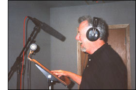 picture of Michael Knott in the recording studio. TV anouncer, narrator, director and producer. He has a deep rich voice like James Earl Jones. Known as 1-800-the-voice, 800 the voice, or just the voice